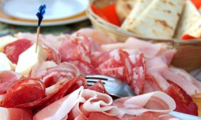 Tagliere di salumi italiani con pane.